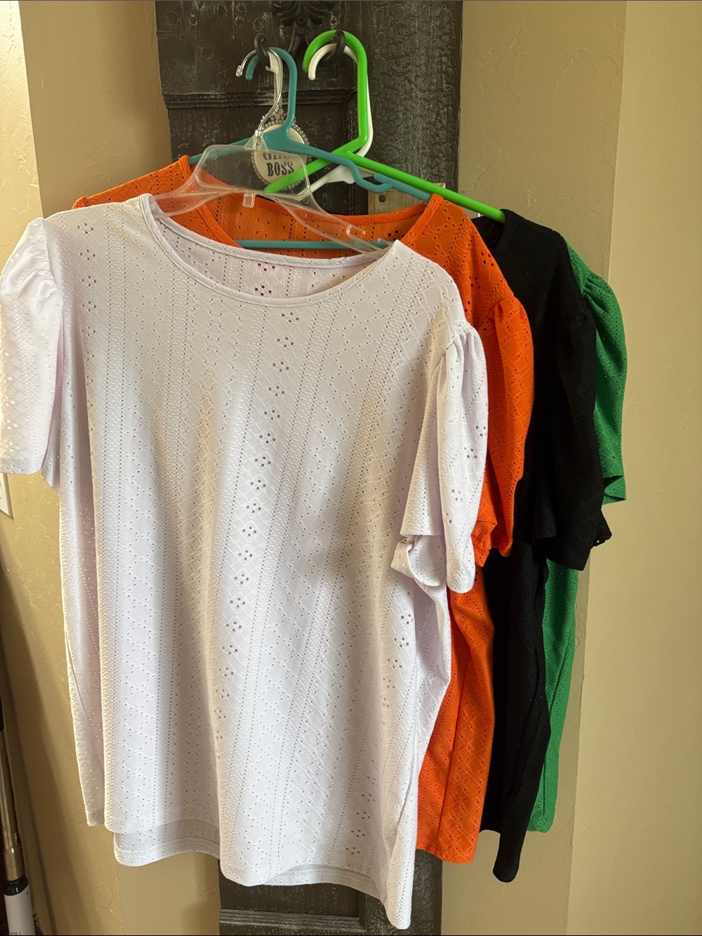Four (4) identical 2X women’s tops, 4 colors